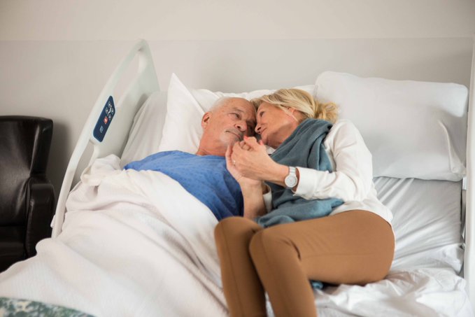 A couple sharing a Cuddle Bed widened to a double
